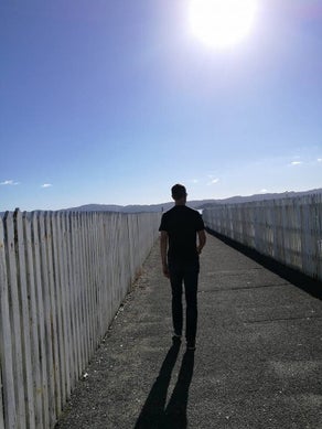 Picture of Tony Stallinger casually walking on Petone wharf