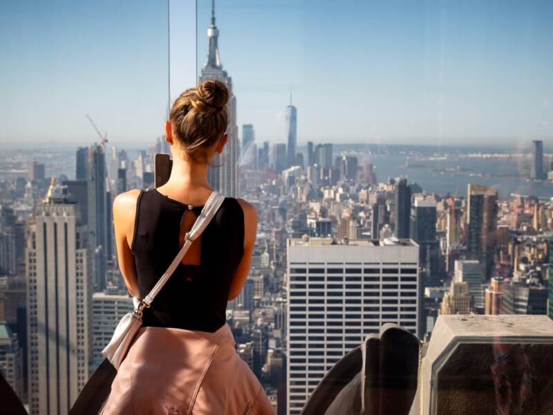 Girl taking photos of the Skyline of Manhattan from the Rockefeller Top of the Rock Center