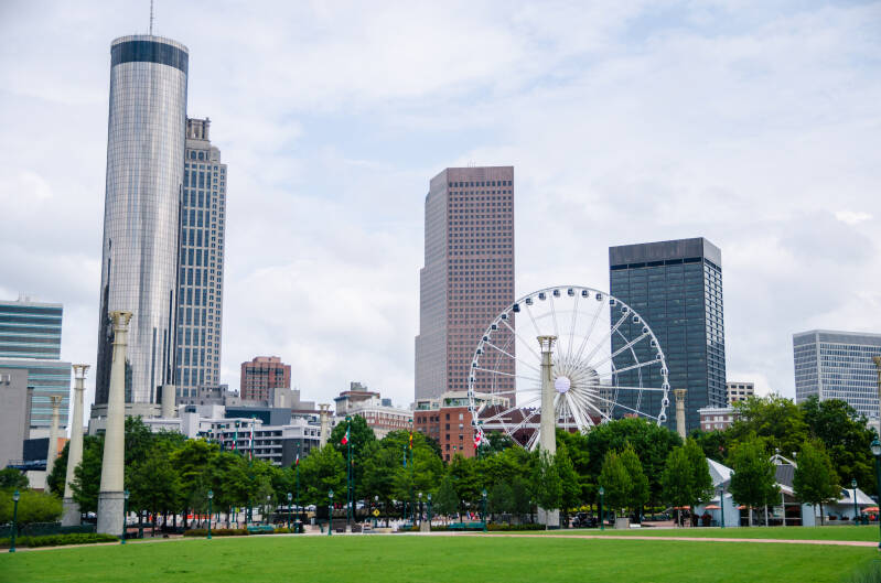 cityscape and green garden with blue sky in cloudy day