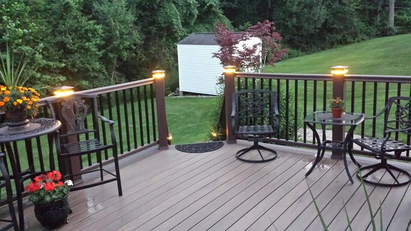 Composite deck with built-in post lighting at dusk