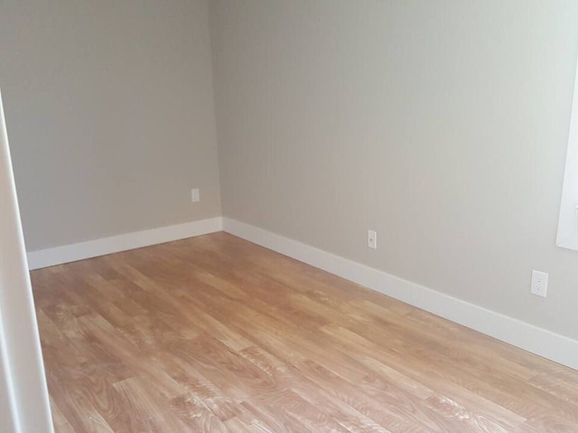Finished room with new flooring and freshly installed base molding