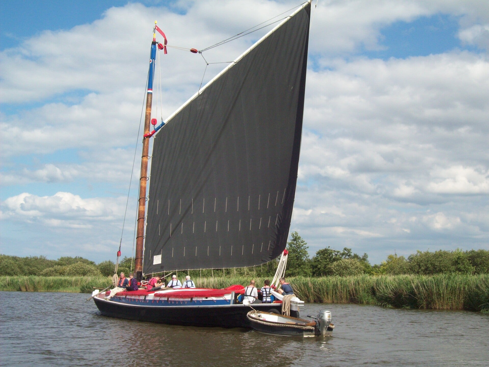 Traditional sailing on the peaceful Norfolk Broads, a highlight of our bespoke British nature tours.