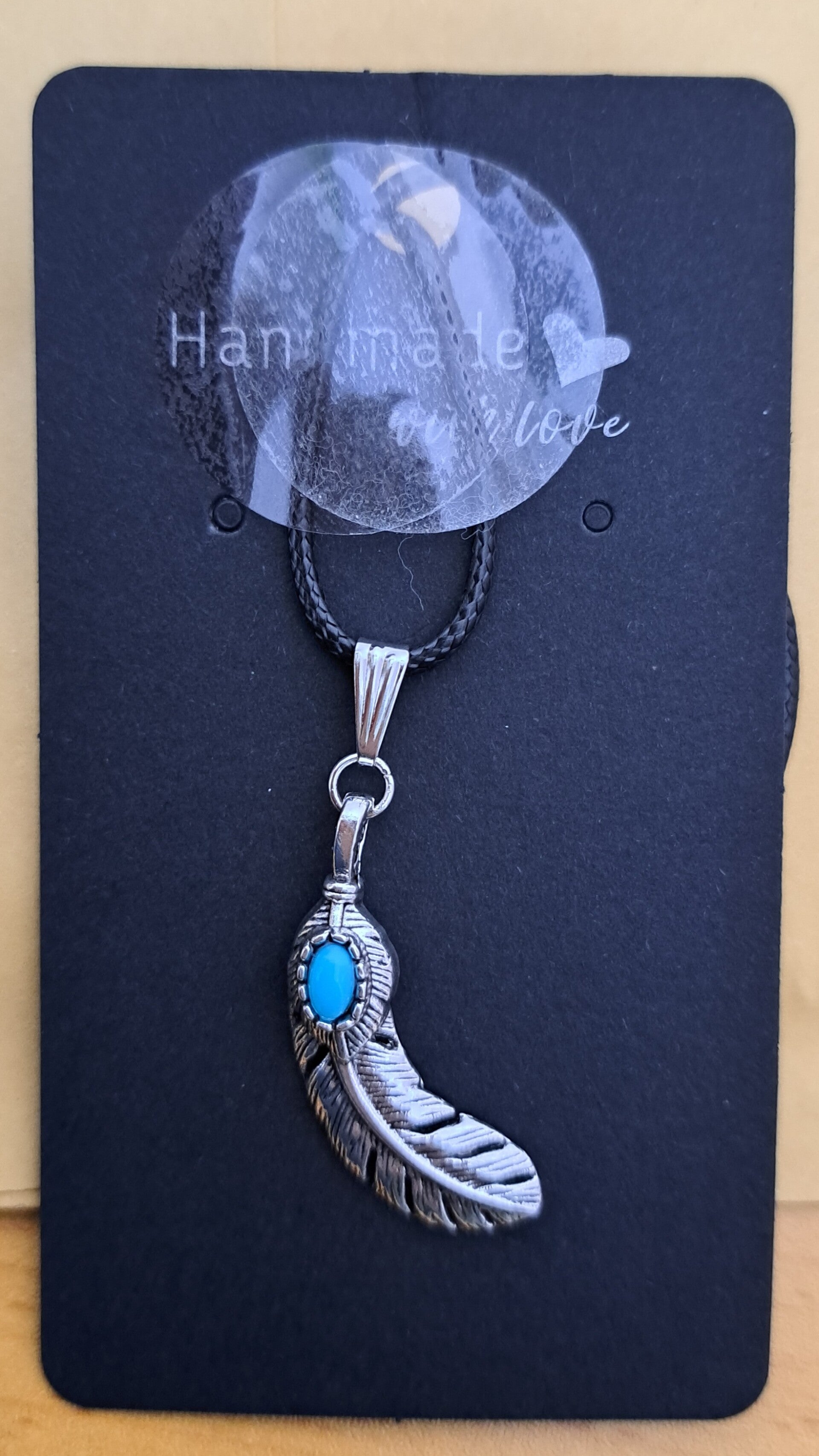 Handmade feather with blue stone pendant