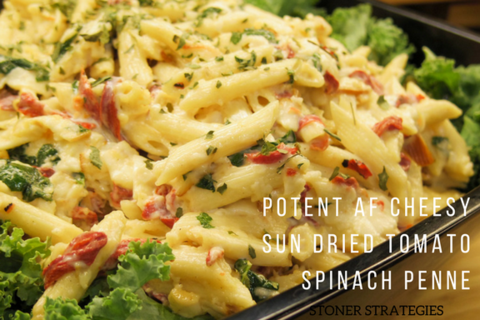 A creamy bowl of penne pasta with sun-dried tomatoes, spinach, and melted smoked Gouda, a perfect choice for cannabis edibles Stoner Strategies
