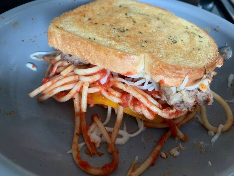 A crispy, melted Cannabis Spaghetti and Meatball Grilled Cheese, the ultimate comfort food for cannabis edibles and stoner strategies enthusiasts