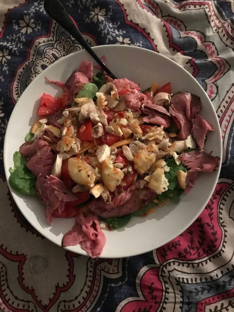 A bowl of Roast Beef Salad with Cannabis Italian Dressing, perfect for cannabis edibles and Stoner Strategies enthusiasts.