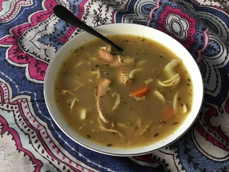 A steaming bowl of Homemade Chicken Noodle Soup, perfect for cannabis edibles and Stoner Strategies enthusiasts