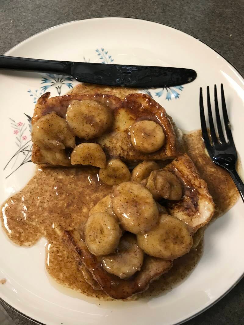 A plate of golden Cannabis French Toast with banana syrup, the perfect brunch for cannabis edibles and Stoner Strategies readers