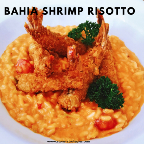 A creamy cannabis shrimp risotto edibles recipe garnished with fresh cilantro and roasted tomatoes in a rustic bowl.