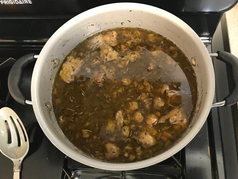 A steaming pot of homemade Cannabis Beef Bone Broth, a nutritious treat for cannabis edibles and Stoner Strategies enthusiasts