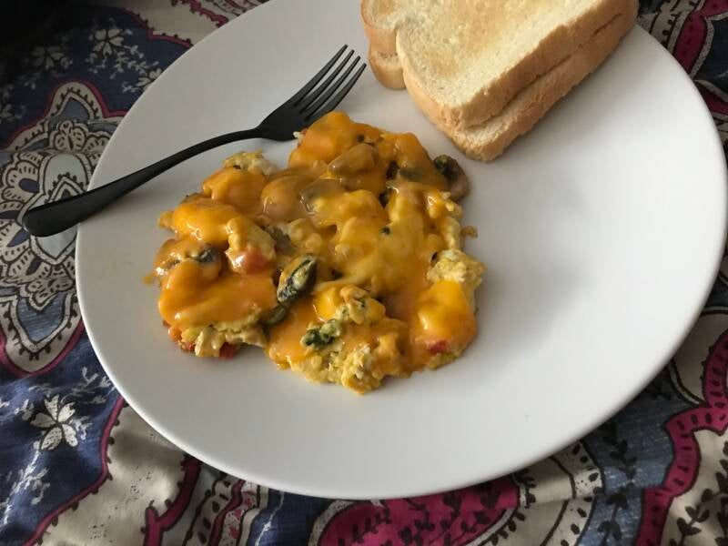 A plate of Cannabis Cheesy Broccoli Mushroom Pepper Scrambled Eggs, perfect for cannabis edibles and Stoner Strategies enthusiasts