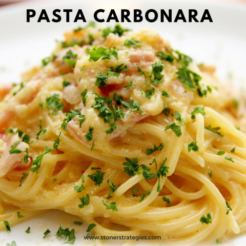 A plate of creamy Cannabis Pasta Carbonara topped with crispy pancetta, parsley, and freshly cracked pepper, a perfect example of cannabis edibles.