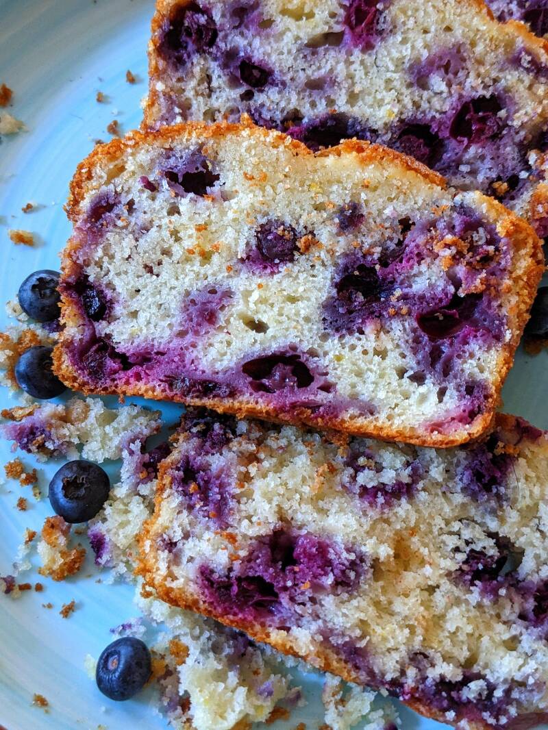 A slice of fresh Cannabis Blueberry Bread, the perfect treat for cannabis edibles and Stoner Strategies readers