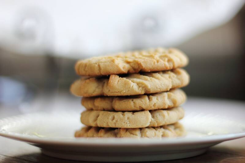 A plate of golden Cannabis White Chocolate Macadamia Nut Cookies, a top-tier treat for cannabis edibles and Stoner Strategies.