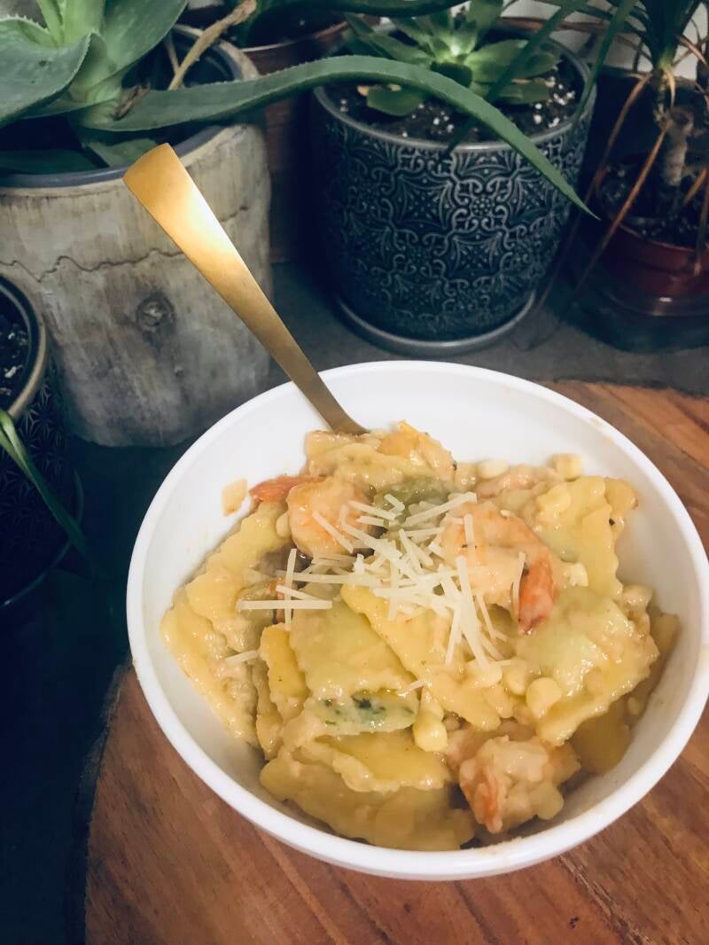 A plate of creamy Cannabis Shrimp and Ravioli in White Wine Cream Sauce, perfect for cannabis edibles and Stoner Strategies enthusiasts.