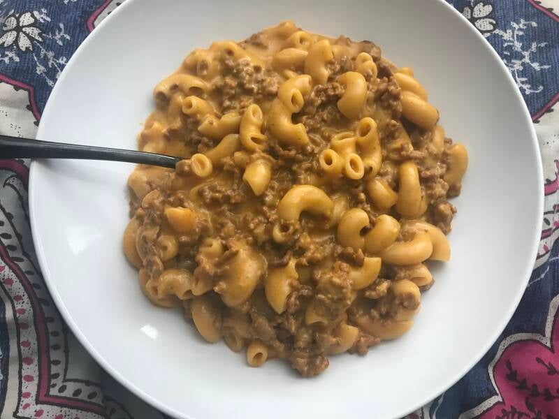 A bowl of creamy, cheesy Hamburger Helper ready for a comforting cannabis infused meal.