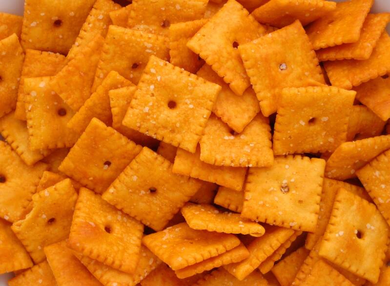 A bowl of crunchy Cannabis Cheese Crackers, the perfect snack for cannabis edibles and stoner strategies enthusiasts.