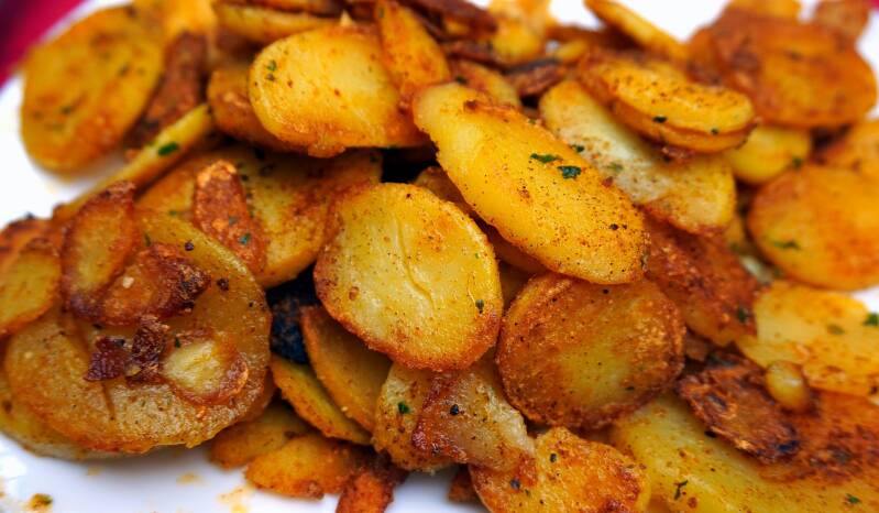 A hot, crispy serving of Cannabis Home Fries, perfect for cannabis edibles and stoner strategies enthusiasts.
