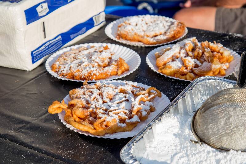 crispy, golden Cannabis Funnel Cakes dusted with cannabis powdered sugar, a perfect carnival-style choice for cannabis edibles and Stoner Strategies readers