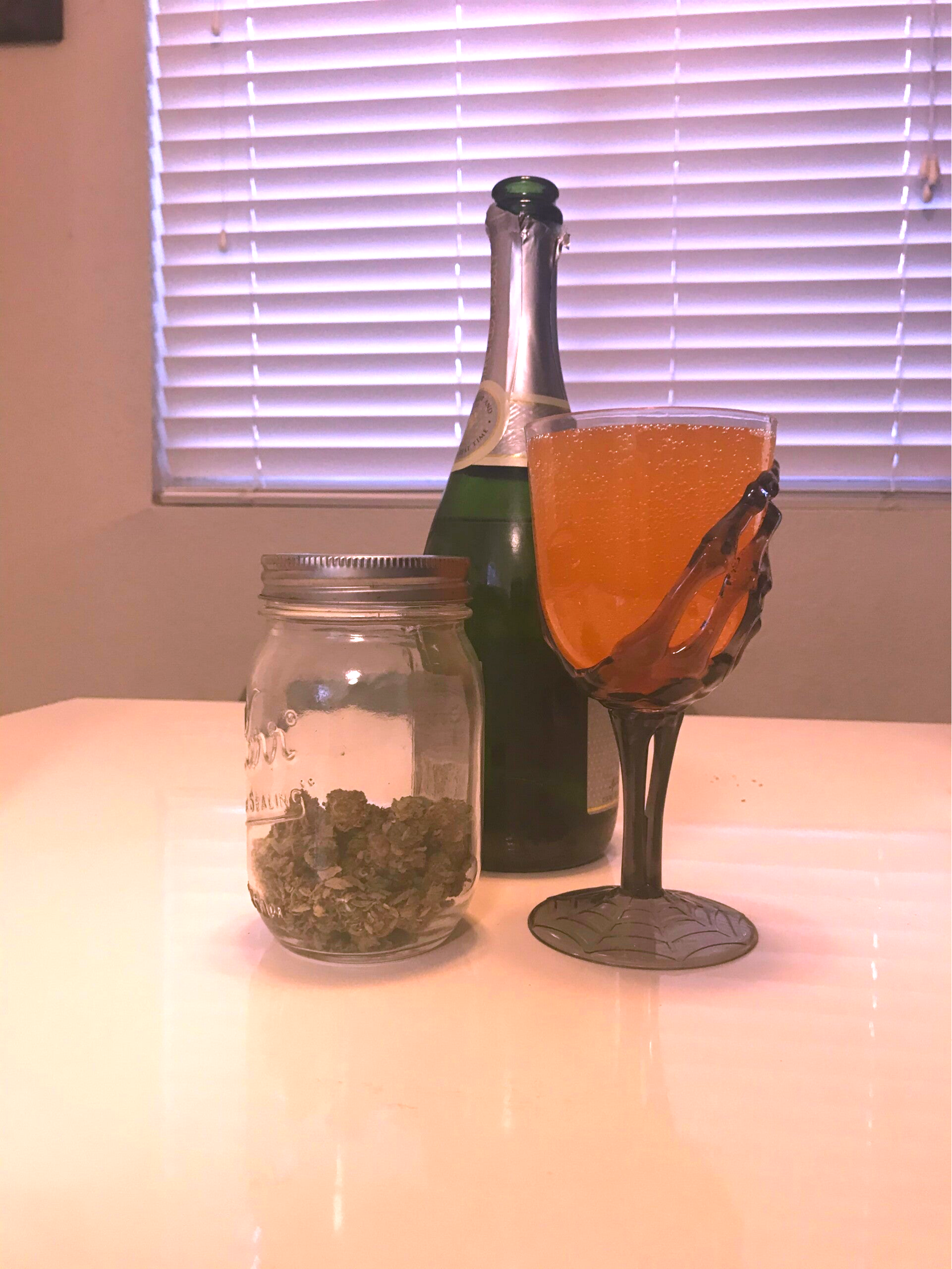 A glass of Peach Mango Cannabis Mimosa, perfect for cannabis edibles and Stoner Strategies enthusiasts.