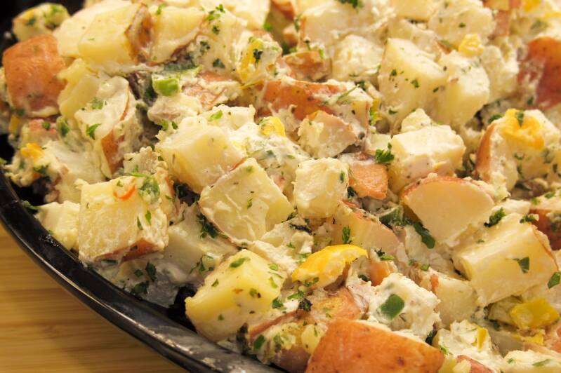 A bowl of creamy, savory Cannabis Potato Salad, perfect for cannabis edibles and stoner strategies enthusiasts.