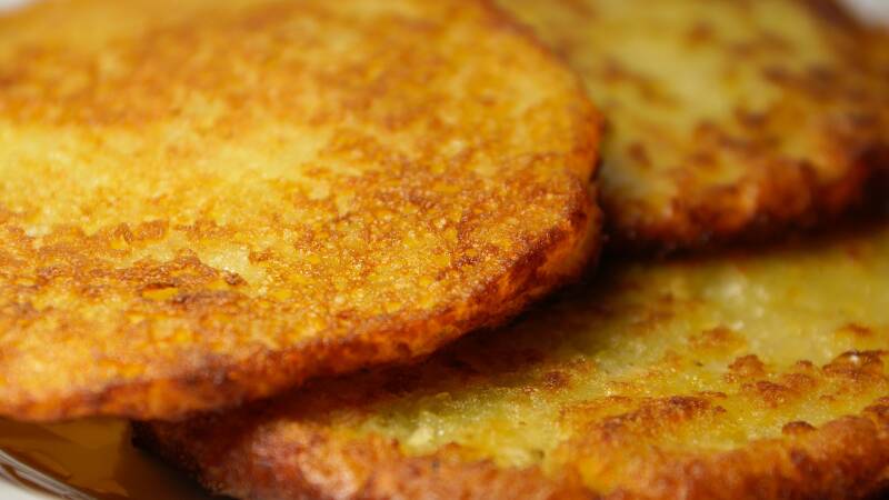 A plate of golden, crispy Cannabis Potato Pancakes, perfect for cannabis edibles and Stoner Strategies enthusiasts.