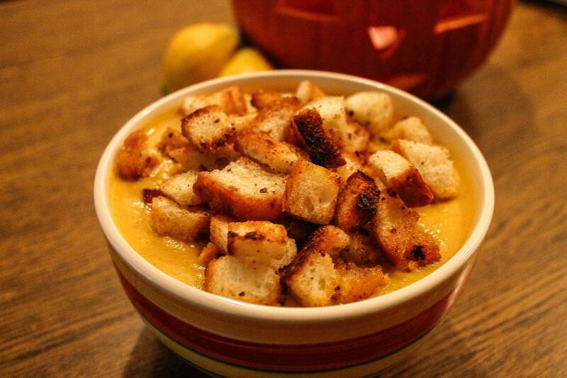 A steaming bowl of Creamy Cannabis Pumpkin Soup, a perfect seasonal treat for cannabis edibles and stoner strategies enthusiasts.