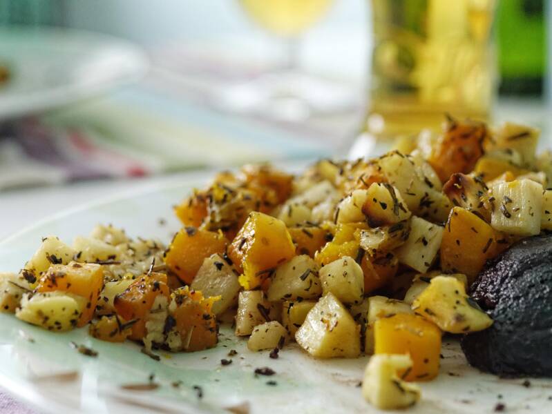 A plate of golden Cannabis Root Hash with sweet potatoes and white potatoes, a top-tier dish for cannabis edibles and Stoner Strategies readers