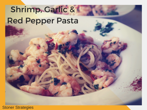 A plate of Cannabis Shrimp, Garlic & Red Pepper Pasta garnished with fresh parsley and Parmesan, an elegant choice for cannabis edibles and Stoner Strategies fans