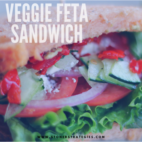 A fresh vegetable sandwich with feta cheese and lettuce on toasted bread, showcasing a healthy infused meal