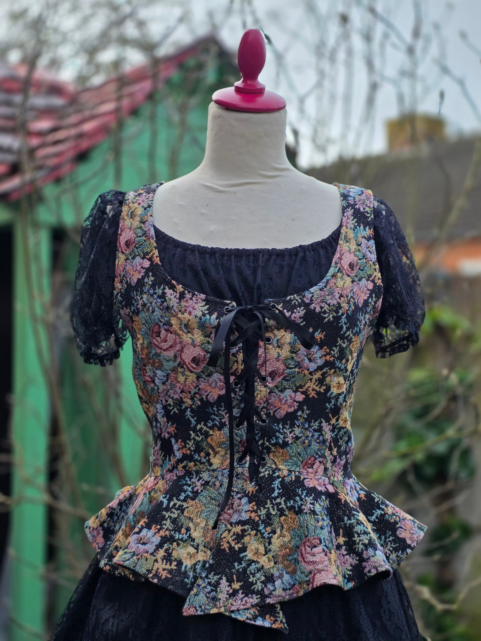 Corset met peplum zwart glitter met bloemenprint M