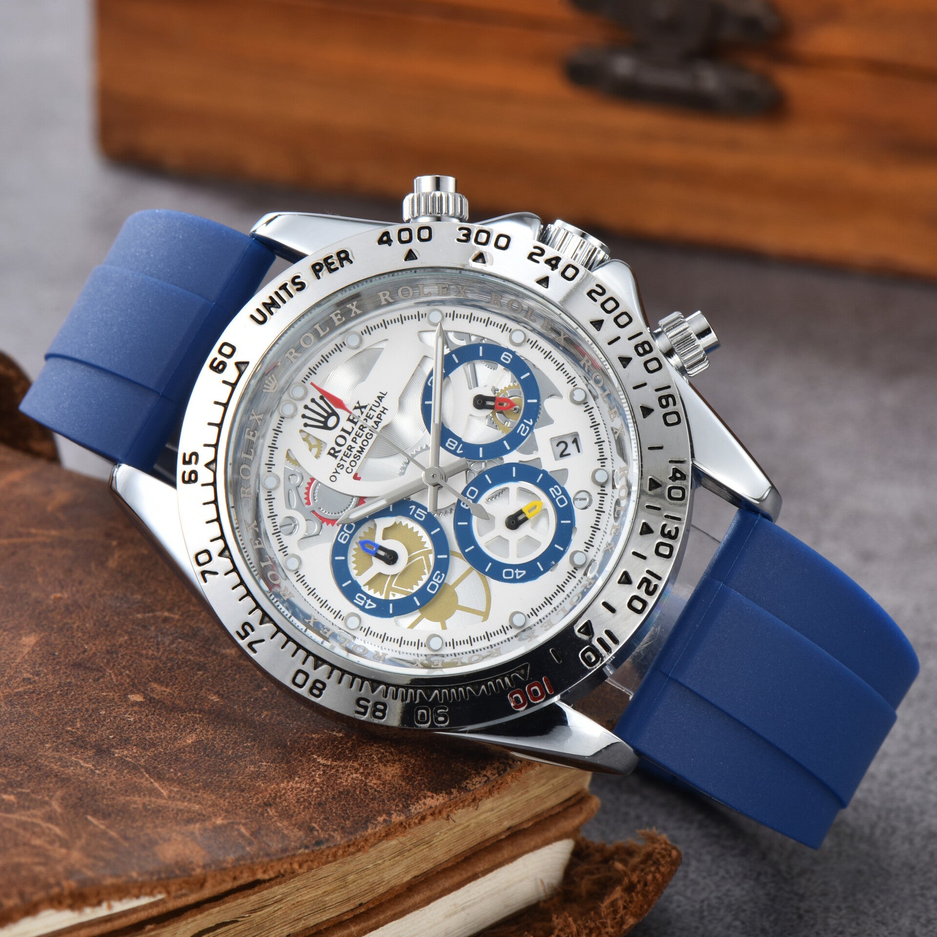 Rolex Cosmograph Daytona with a round dial and a blue silicone strap