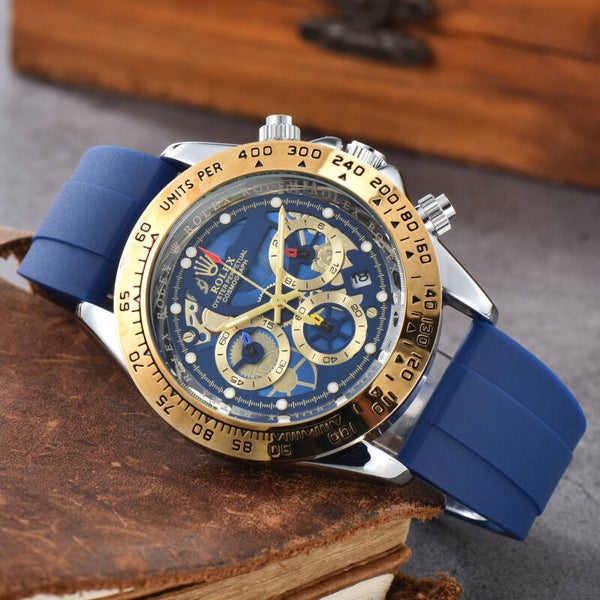 Rolex Cosmograph Daytona with a blue dial, gold-tone bezel, and blue rubber strap
