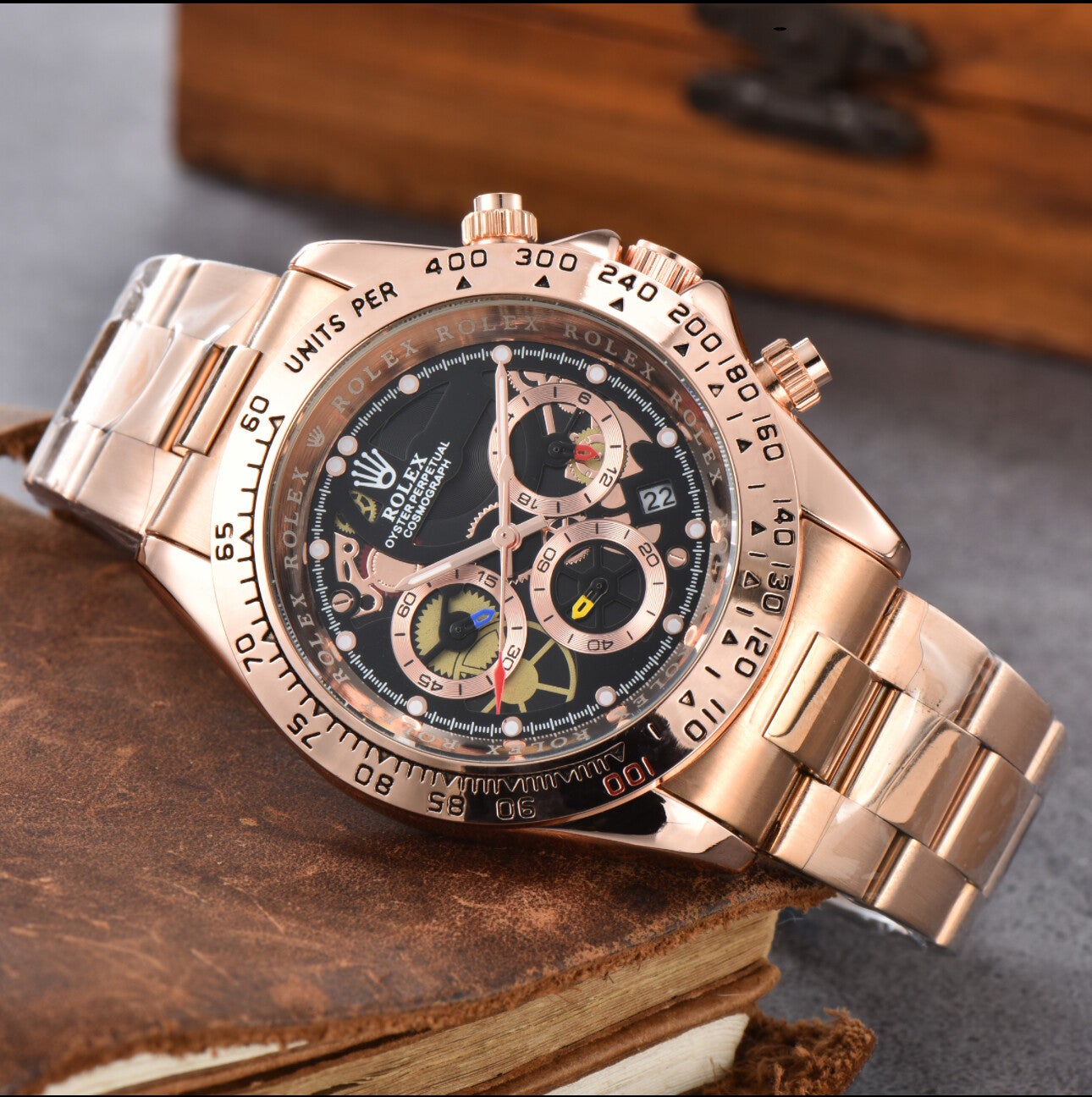 Rolex Cosmograph Daytona with a rose gold-tone case and bracelet, and a black dial