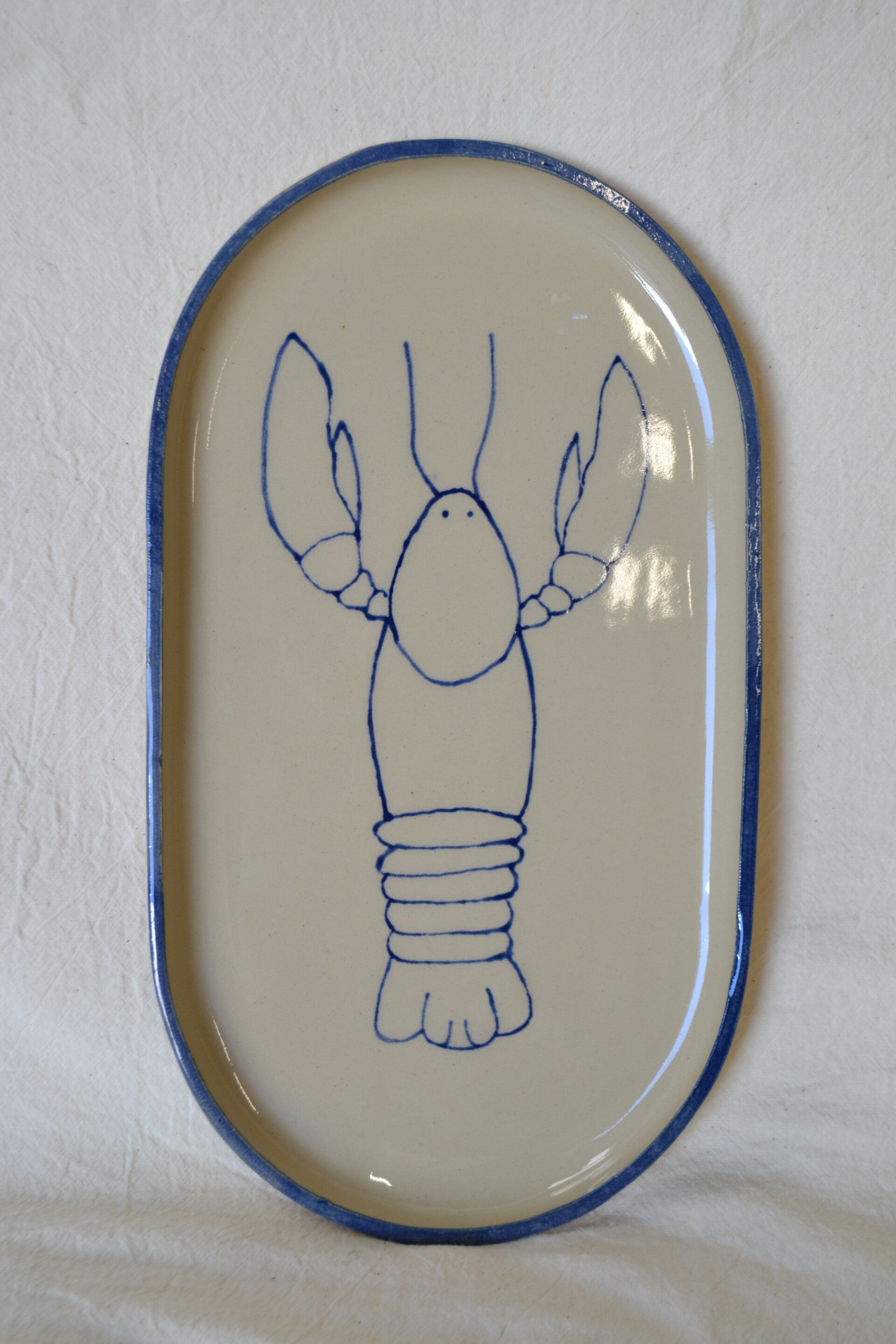 Grote ovaal bord met kreeft