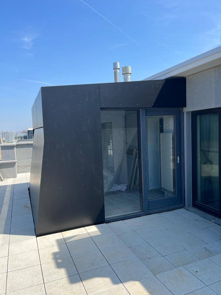 Uitbouw afgewerkt in zwarte trespa