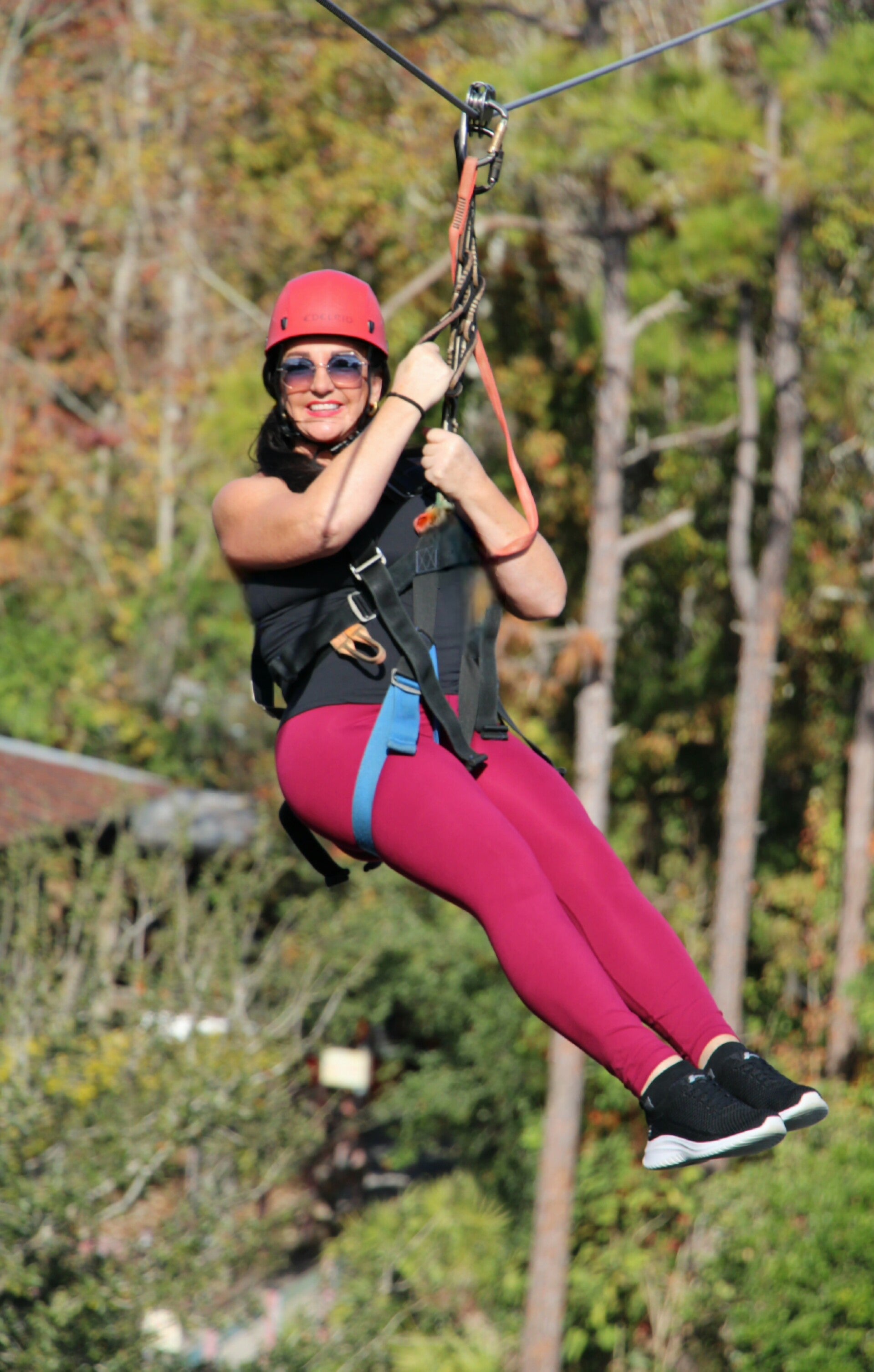 Travel writer Terri Guthrie ziplining over alligators at the Screamin' Gator Zipline during a tourism board press trip in Central Florida.