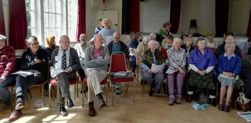 East Lancs Clarion Choir members together with members of other local choirs at Downham Village Hall, for the Pendle Hill Singing Project in 2019 
