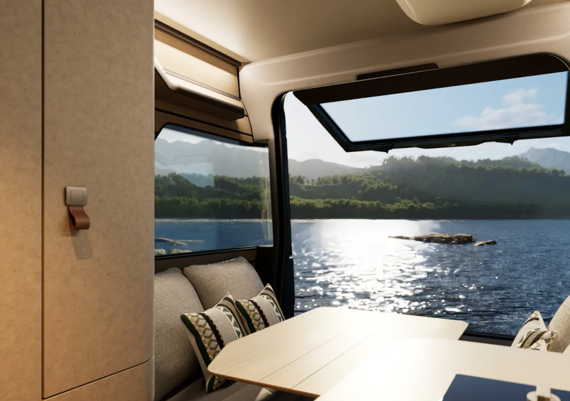 Intérieur du Venture S avec table de repas, banquettes et vue panoramique sur un lac à travers une grande fenêtre