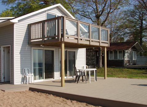 Composite deck with glass railing