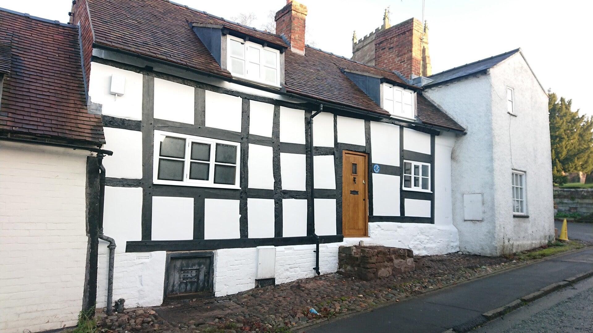 Grade 2 listed farmhouse in Malpas, Cheshire West and Chester. Black and white timber frame that was restored using traditional joinery skills and best conservation practise. The infill panels were plastered using lime based mortar.
