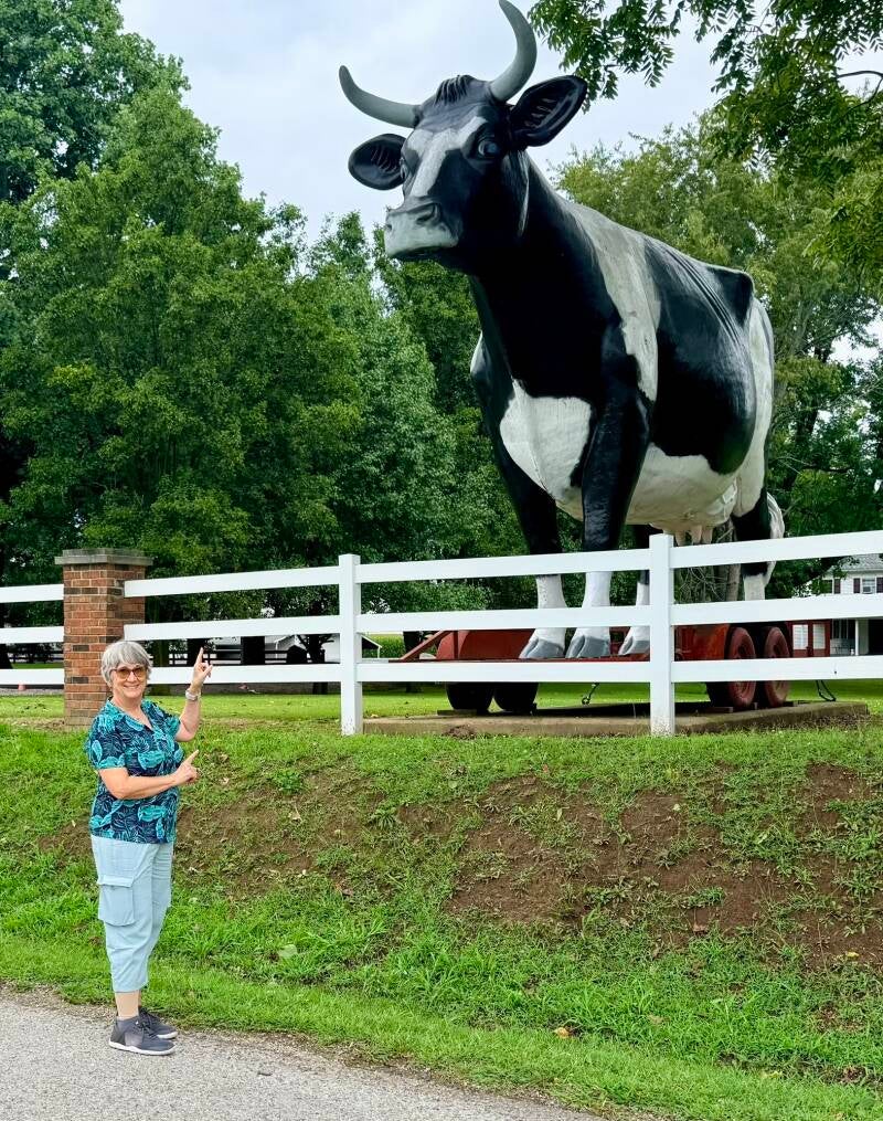 Me standing in front of a giant cow statue. 