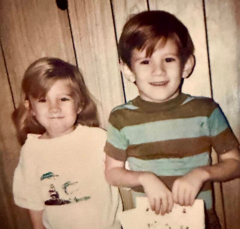 Little blonde 2 year old girl and 4 year old boy with large ears. 
