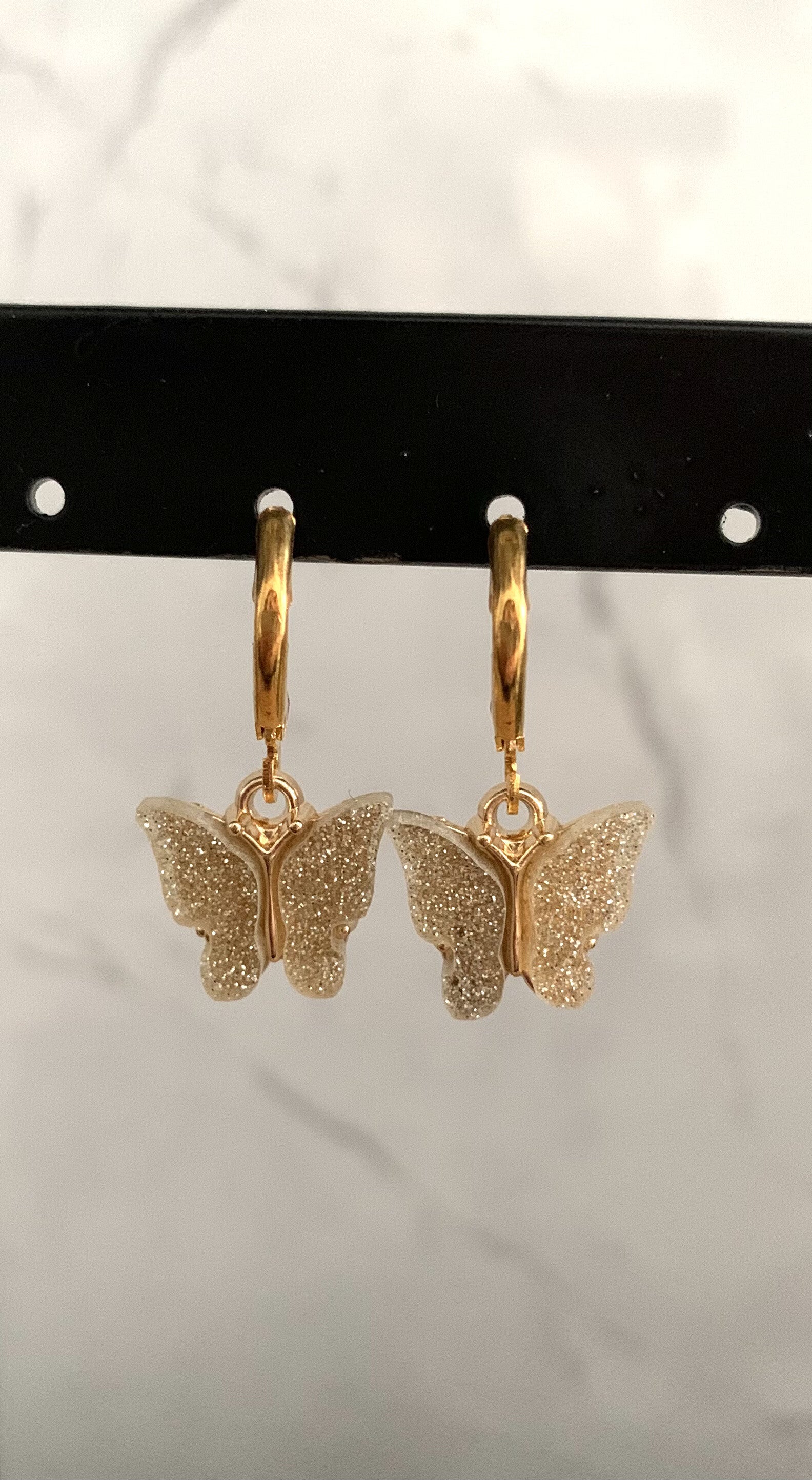The gold butterfly earrings