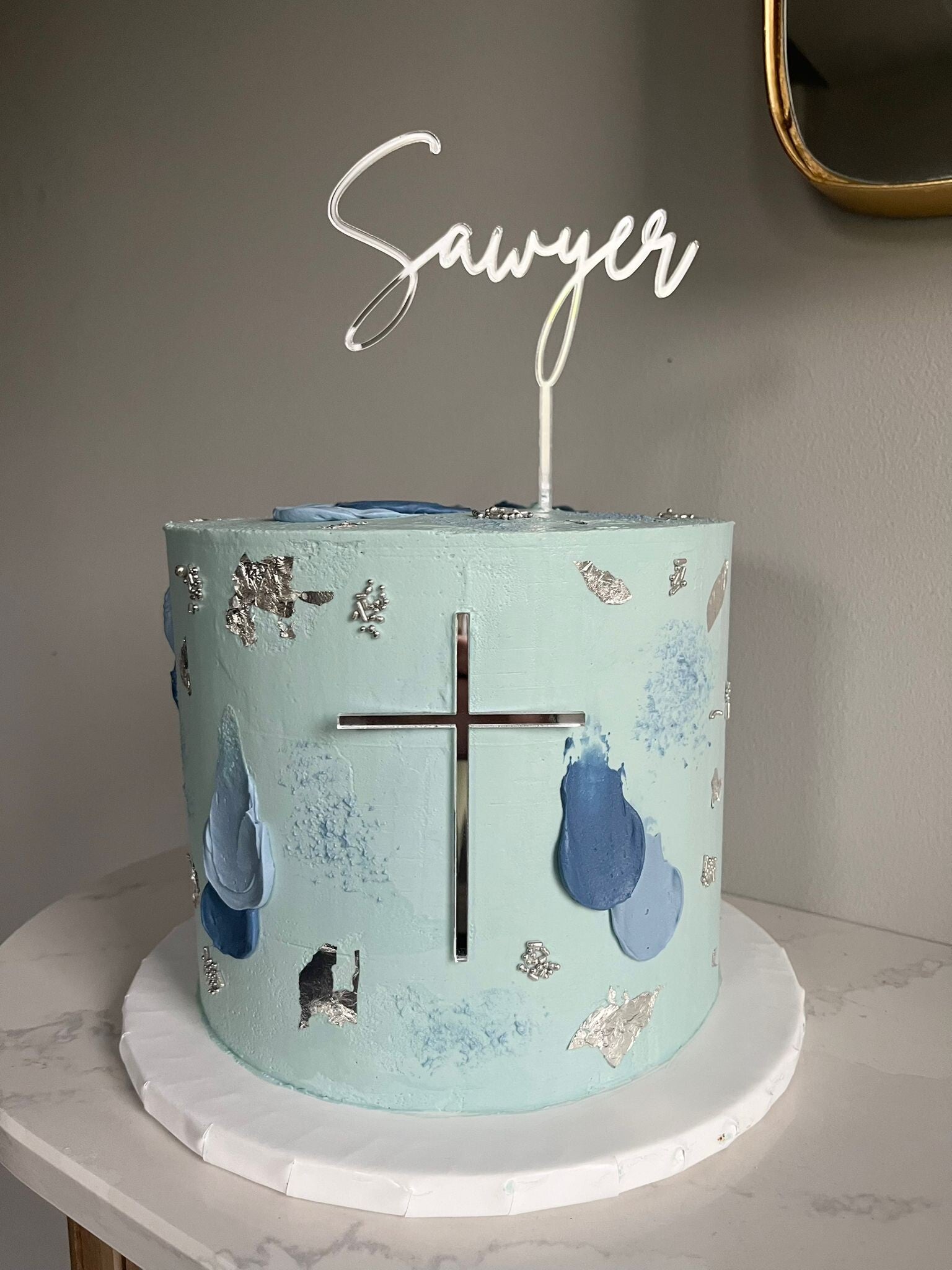 Communion celebration cake in blue and silver decoration.