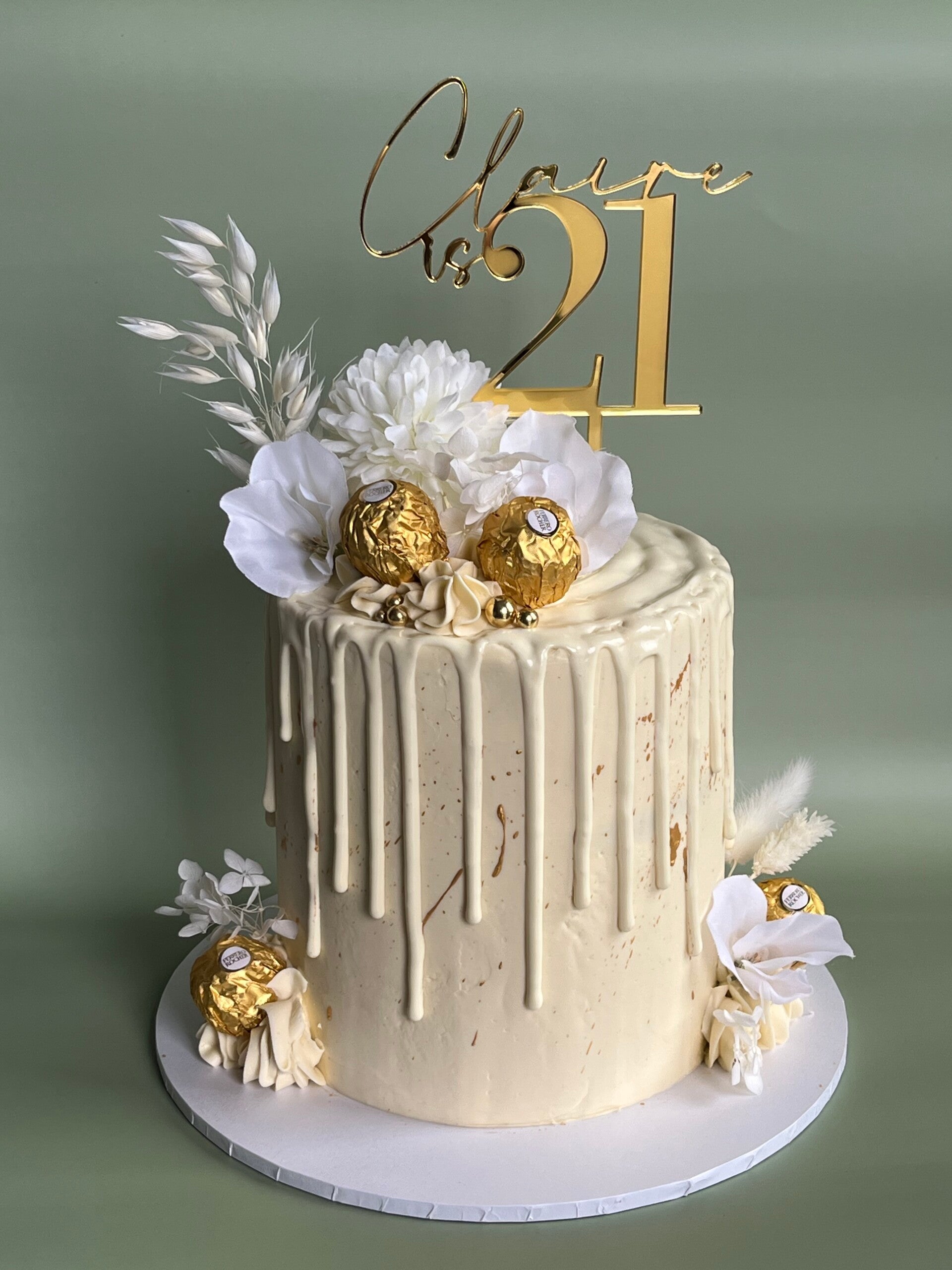 Tall swiss meringue buttercream 50th birthday cake in green with pink floral decoration.