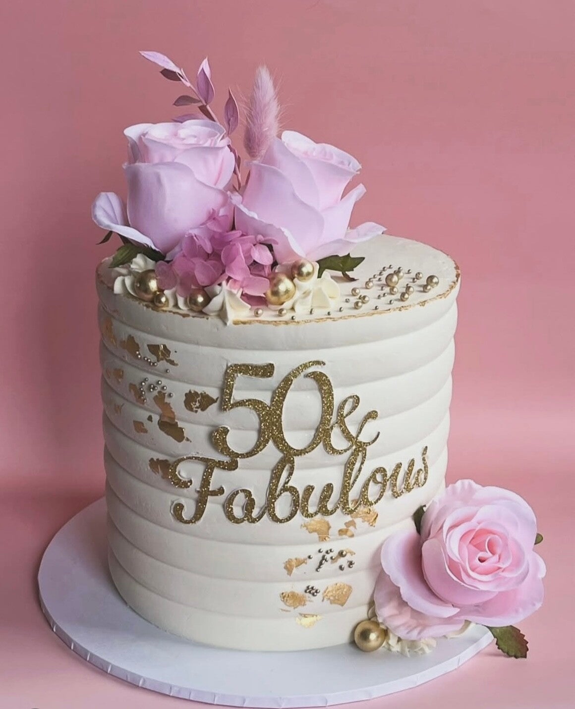 Small 6 inch swiss meringue buttercream cake in cream and dusty pink and blue