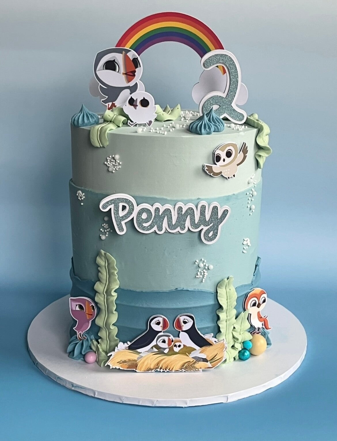 A box of 12 cupcakes as a thank you present for teachers. Decorated in bright colours, red, yellow green.