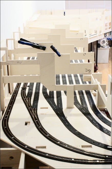 afbeelding van het schaduwstation met 9mm multiplex plaat als onderlegger voor de moderails. Het zwarte materiaal op de foto is akoestisch dempend rubbergranulaat onder de modelrails om het geluid van rijdende treinen te reduceren.