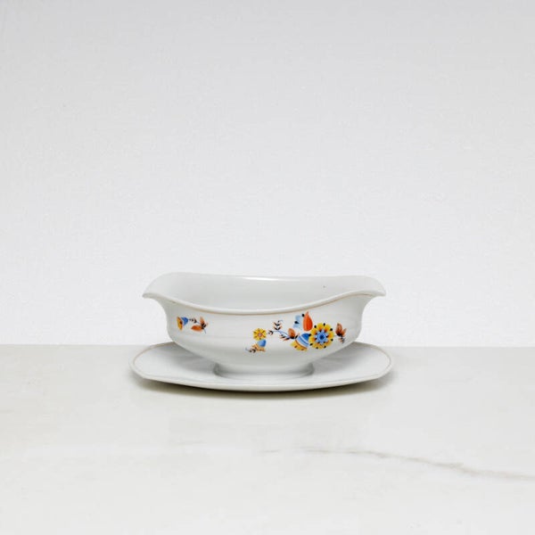 Mosa Maastricht ovale sauskom met een geel-blauw bloemmotief en een goudkleurige rand